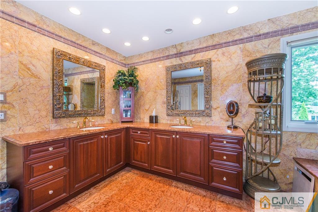 16 Ron's Edge Road Springfield, NJ 07081 - Photo 13 of 25 a spacious bathroom with a granite countertop sink and a mirror