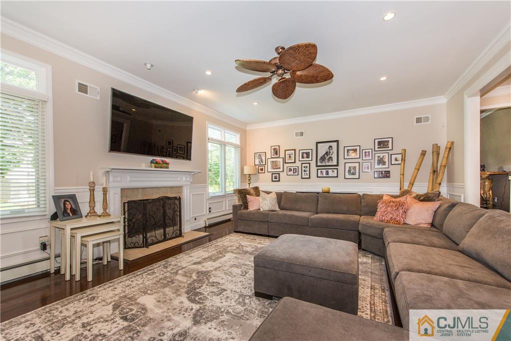16 Ron's Edge Road Springfield, NJ 07081 - Photo 6 of 25 a living room with furniture a fireplace and a flat screen tv