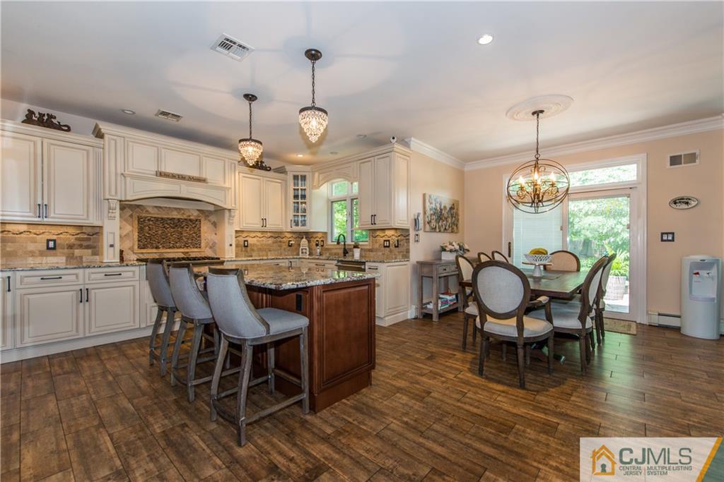16 Ron's Edge Road Springfield, NJ 07081 - Photo 7 of 25 a kitchen with wooden floors and wooden cabinets