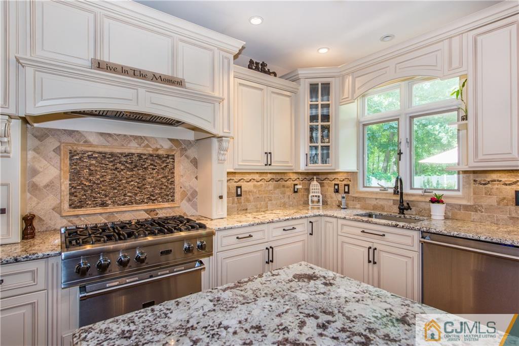 16 Ron's Edge Road Springfield, NJ 07081 - Photo 8 of 25 a kitchen with a stove a sink and a window