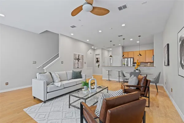 a living room with furniture and kitchen view
