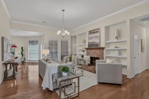a living room with fireplace furniture and a chandelier