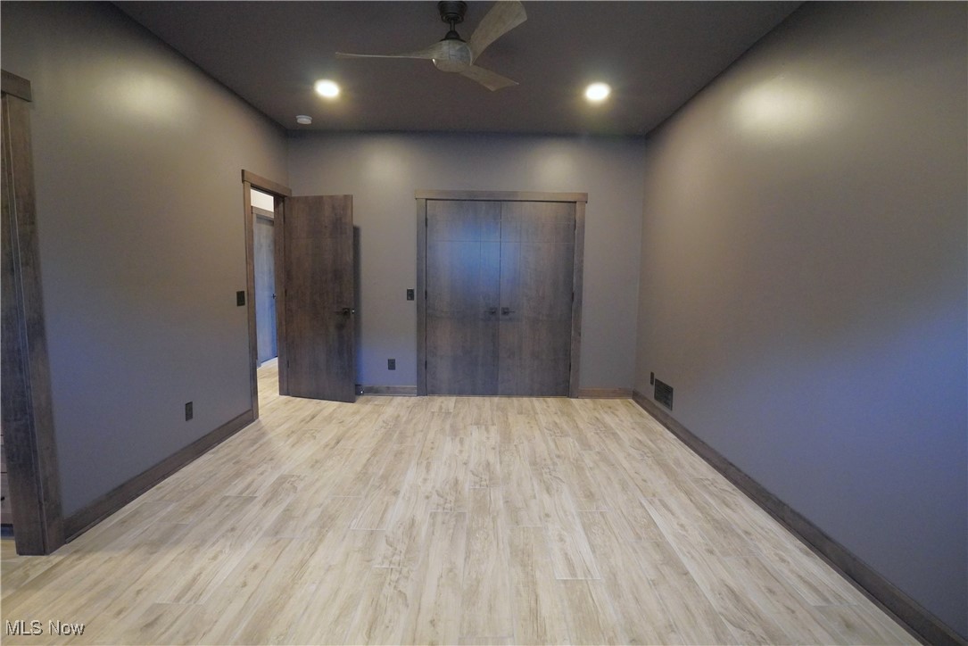 2502 Charing Cross Road Northwest Canton, OH 44708 - Photo 11 of 12 Oversized Master bedroom with a huge walk-in closet, ceramic plank flooring, and ceiling fan adjoins the incredible Master bath