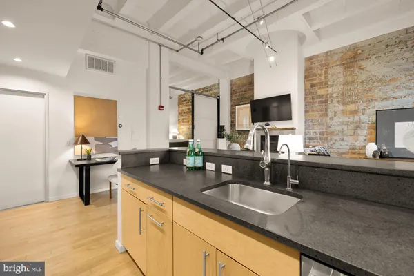 a kitchen with sink stove and granite counter top