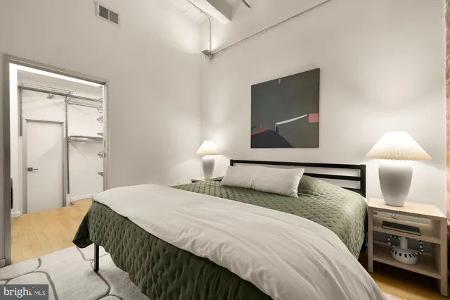 a bedroom with a bed and a lamp on table