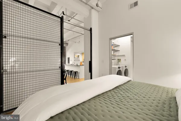 a bedroom with a bed and a chandelier