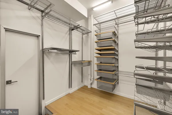 a view of walk in closet with empty racks