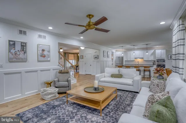 a kitchen with stainless steel appliances granite countertop a kitchen island a stove a table and chairs in it