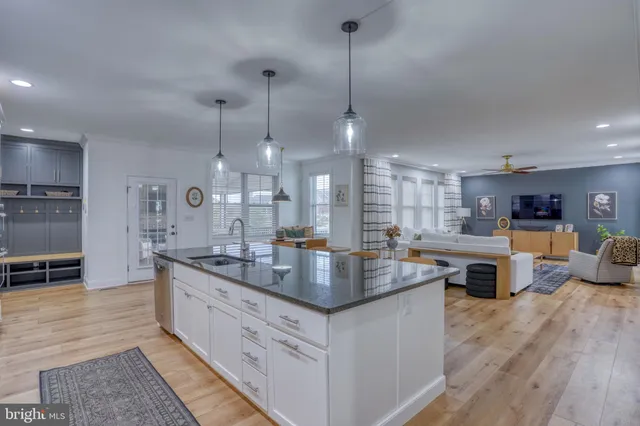 a living room with furniture a fireplace and a floor to ceiling window