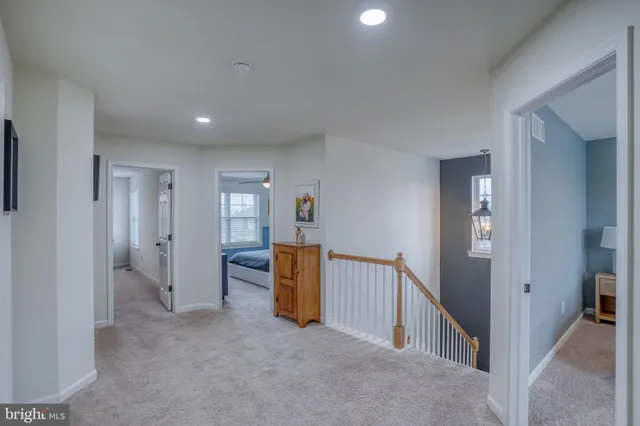 a bedroom with a bed a dresser and a window