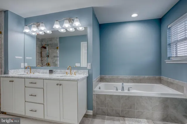 a view of an empty room with kitchen and a table chairs