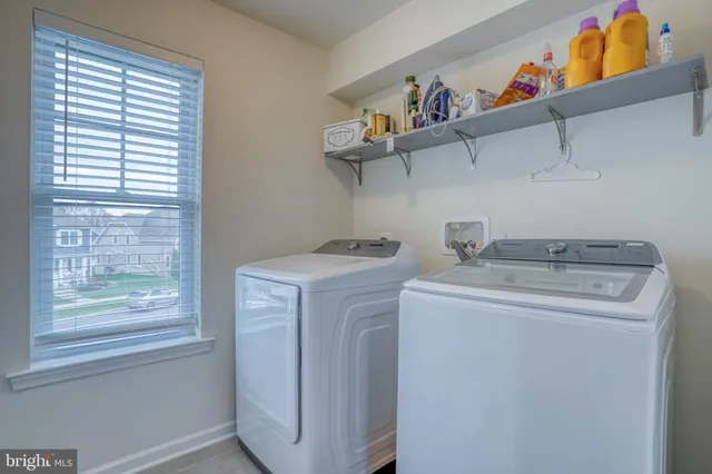 a front view of a house with a garden and yard