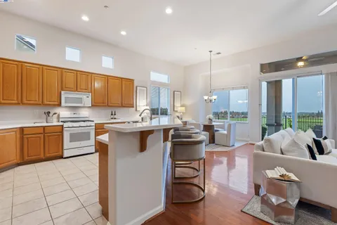a kitchen with stainless steel appliances granite countertop a sink stove and cabinets