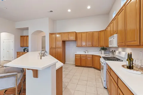 a open dining room with furniture a window and a chandelier