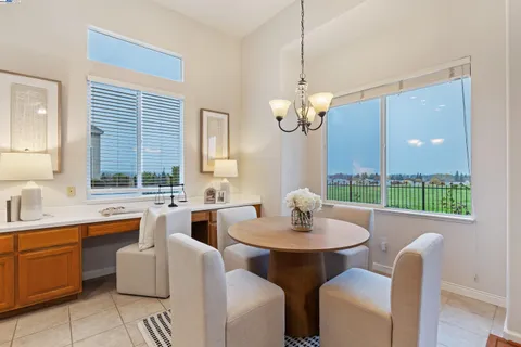 a kitchen with stainless steel appliances granite countertop a sink and a white cabinets
