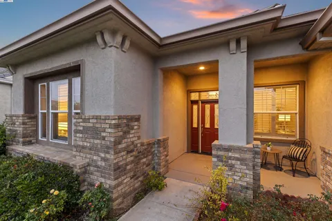 a front view of a house with outdoor seating