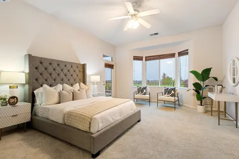 a bedroom with a large bed and a window