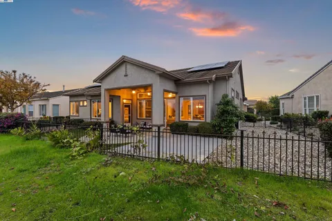 an aerial view of a house with yard and balcony
