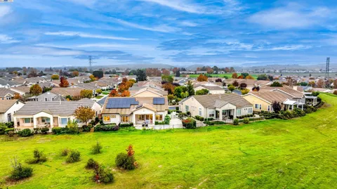 a swimming pool with outdoor seating and yard