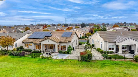 a room with furniture a large window and a chandelier