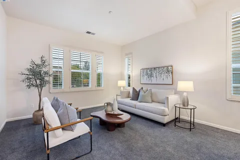 a living room with furniture a rug and a chandelier