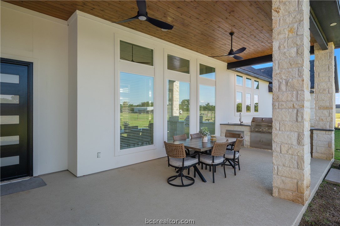 13504 Hudson Farms Road Hearne, TX 77859 - Photo 35 of 48 Resort-Style Outdoor Living
Entertaining is effortless with a spectacular 40x18 summer kitchen featuring a built-in BBQ, sink and fridge space. Unwind in the evenings around the covered fire pit, surrounded by lush, manicured lawns kept vibrant by an integrated sprinkler system.
