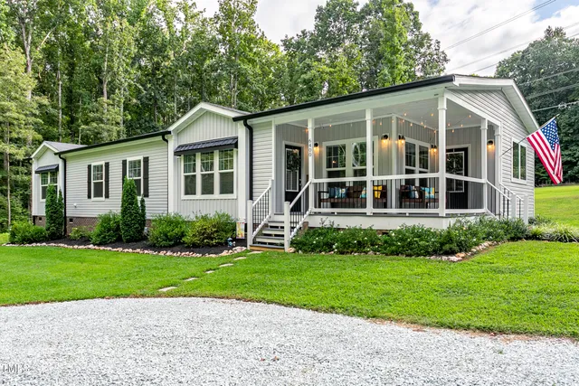 a view of a house with a yard and plants