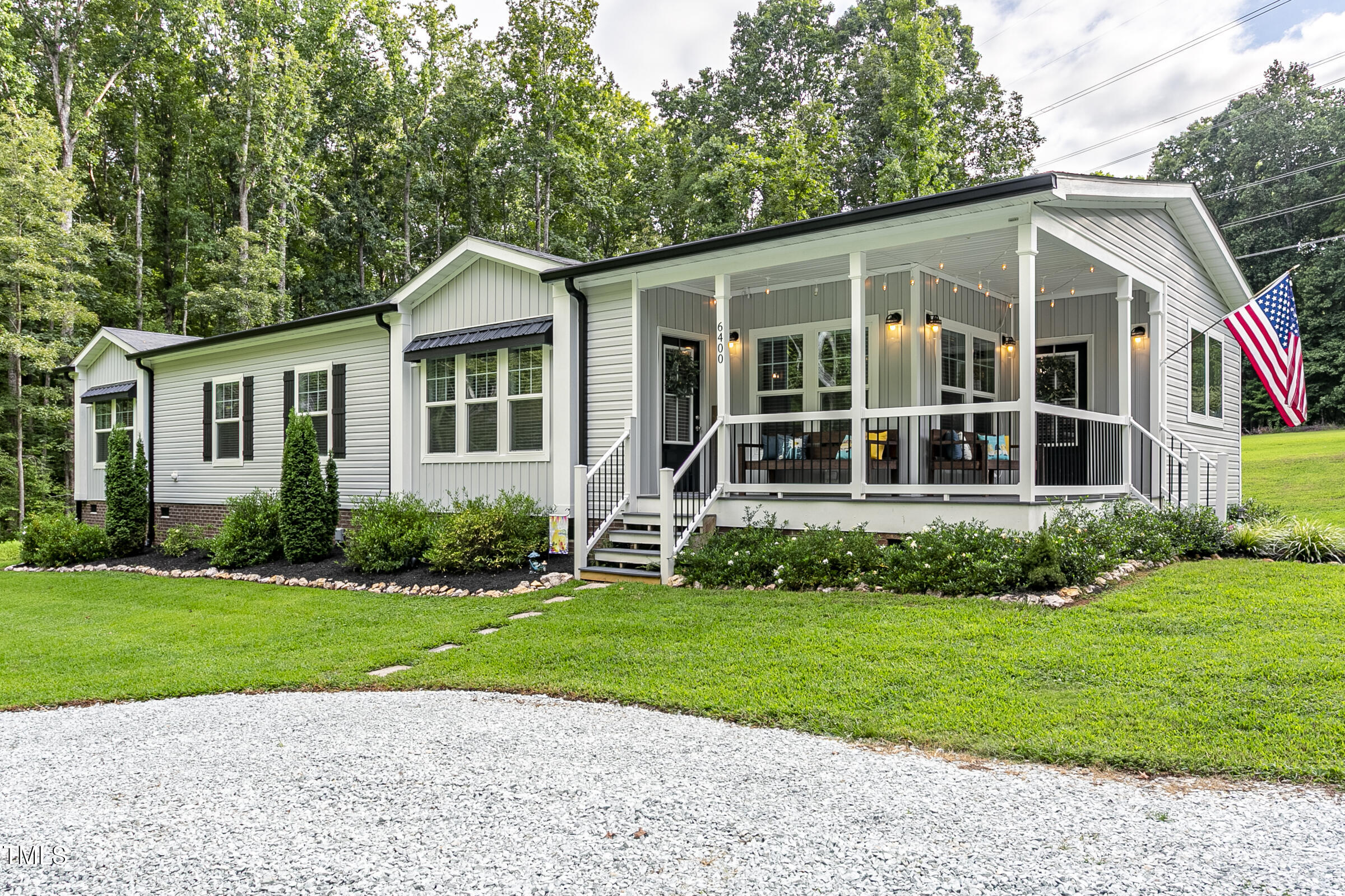 a view of a house with a yard and plants