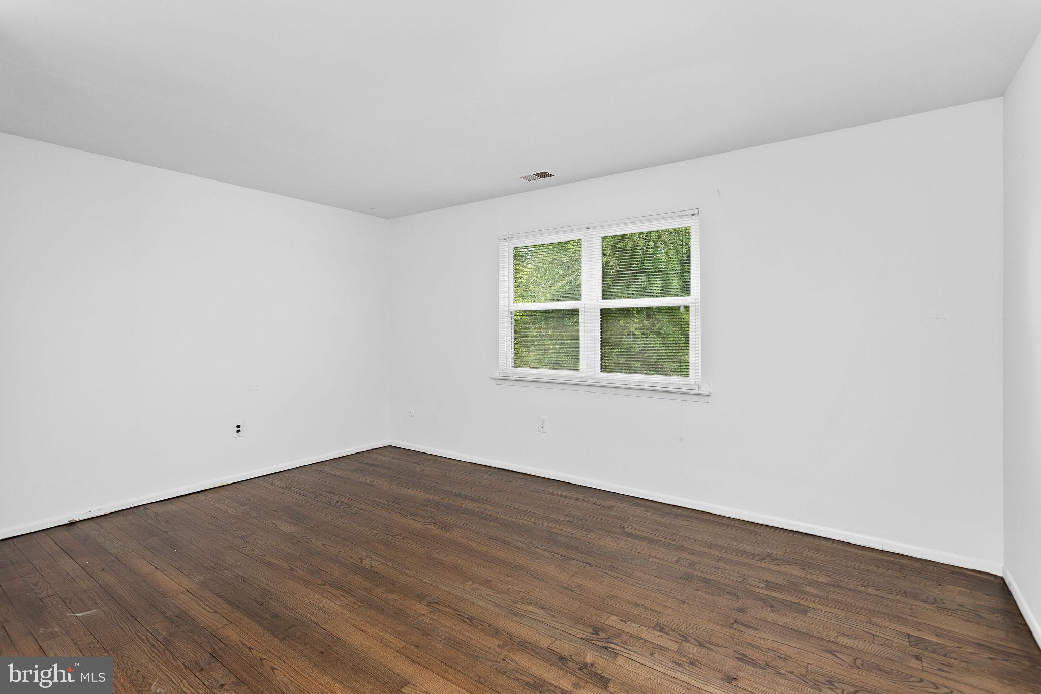 615 Silver Court Hamilton, NJ 08690 - Photo 12 of 22 an empty room with wooden floor and windows