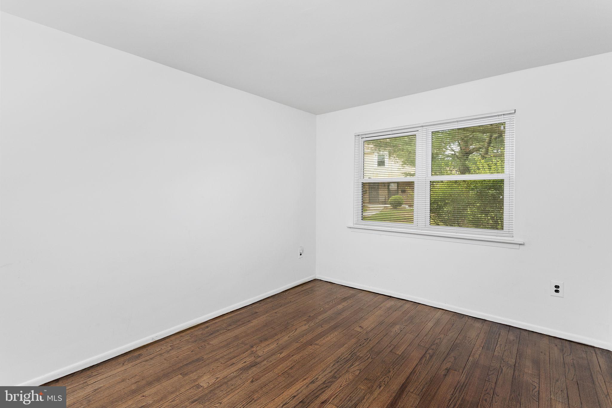 615 Silver Court Hamilton, NJ 08690 - Photo 16 of 22 a view of an empty room with wooden floor and a window