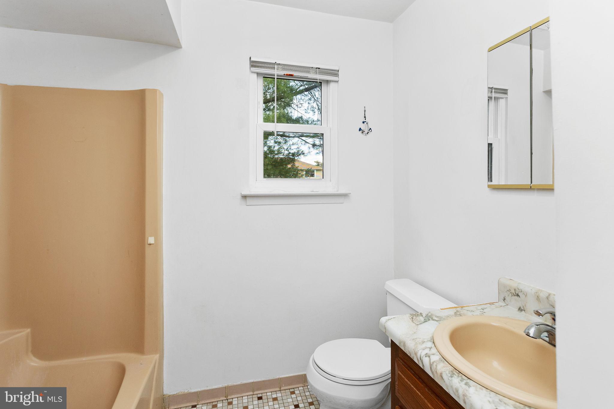 615 Silver Court Hamilton, NJ 08690 - Photo 18 of 22 a white toilet sitting next to a bathroom sink