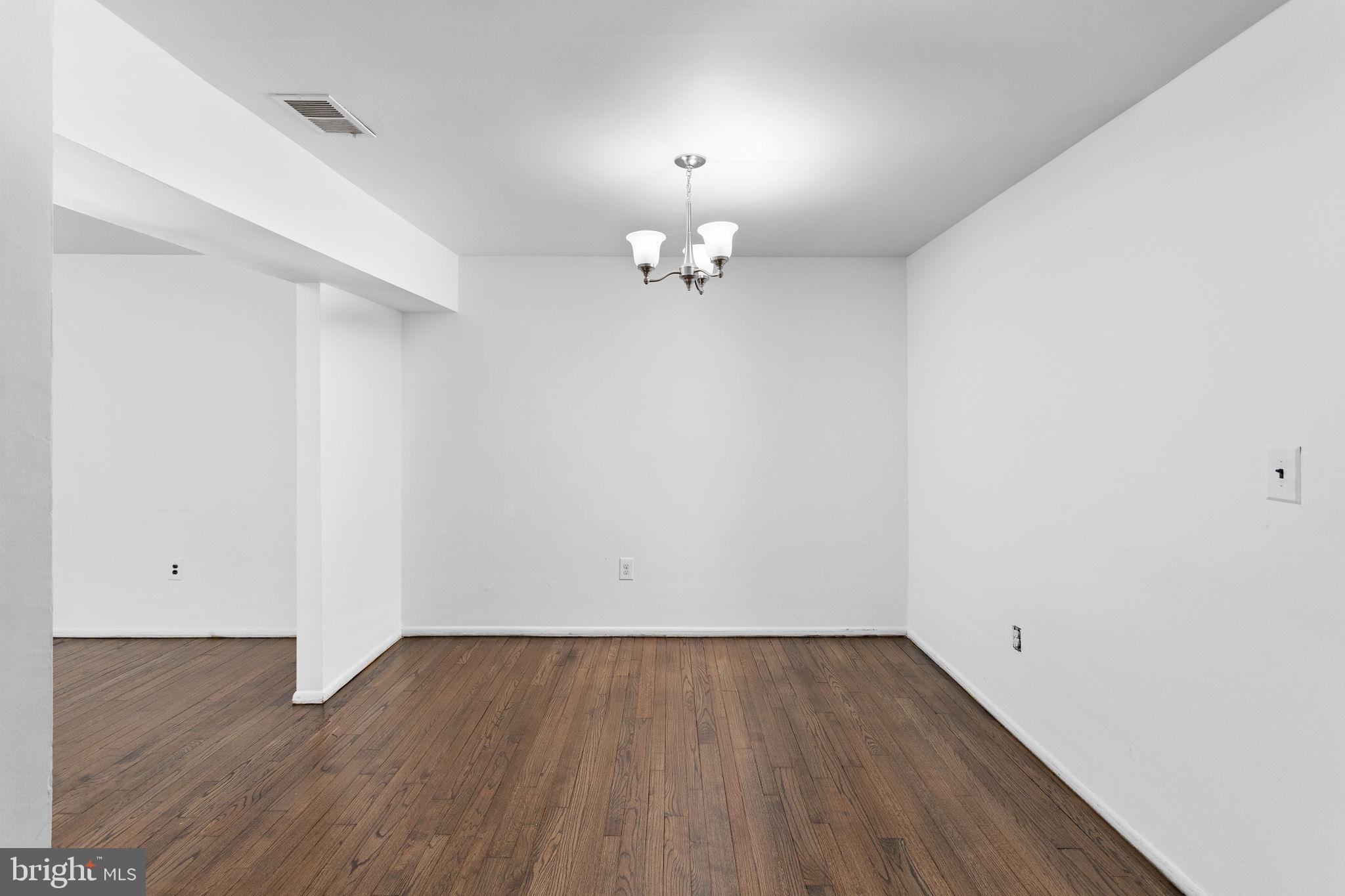 615 Silver Court Hamilton, NJ 08690 - Photo 5 of 22 wooden floor in an empty room with a window