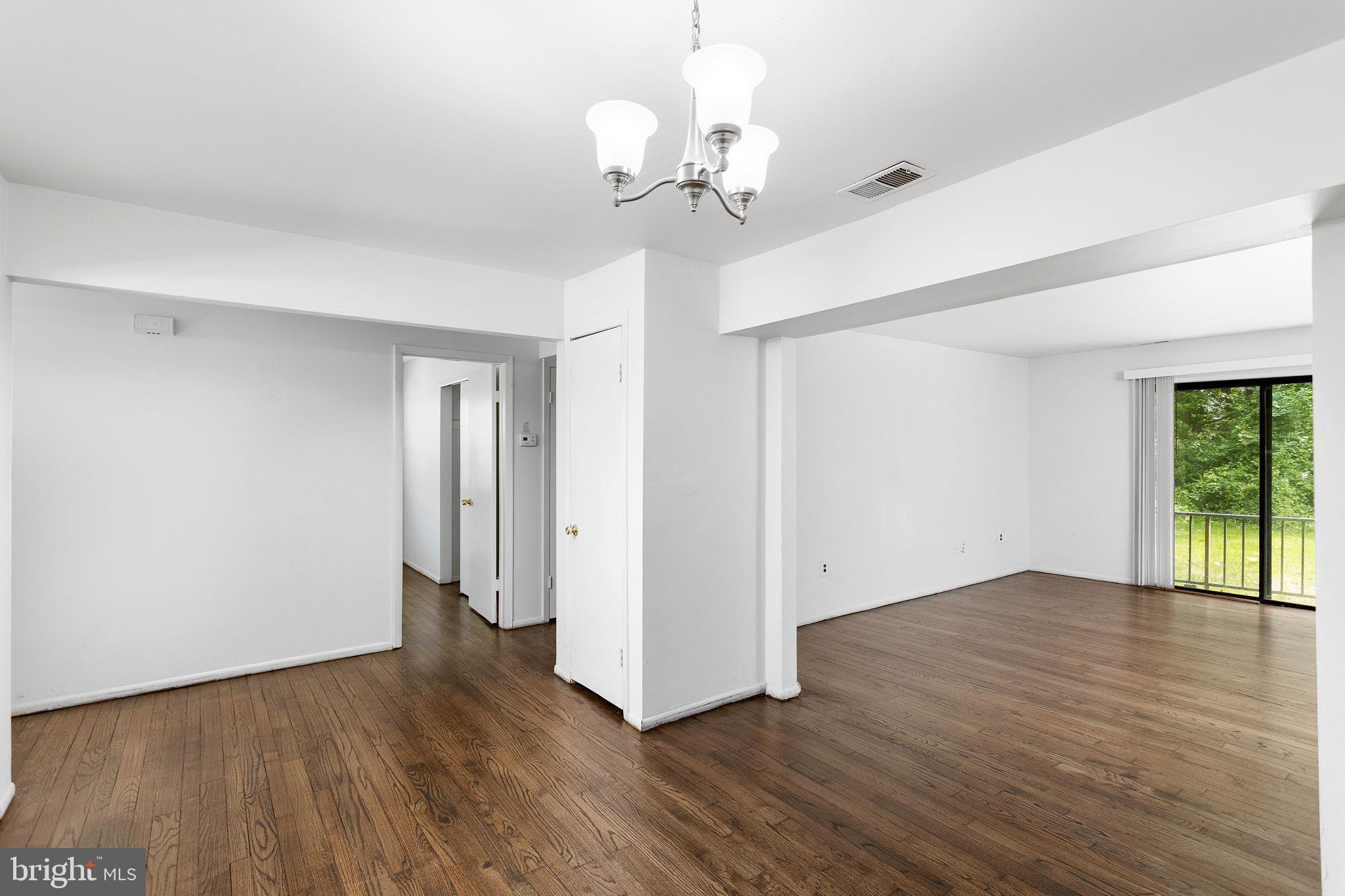 615 Silver Court Hamilton, NJ 08690 - Photo 6 of 22 a view of an empty room with wooden floor and a window