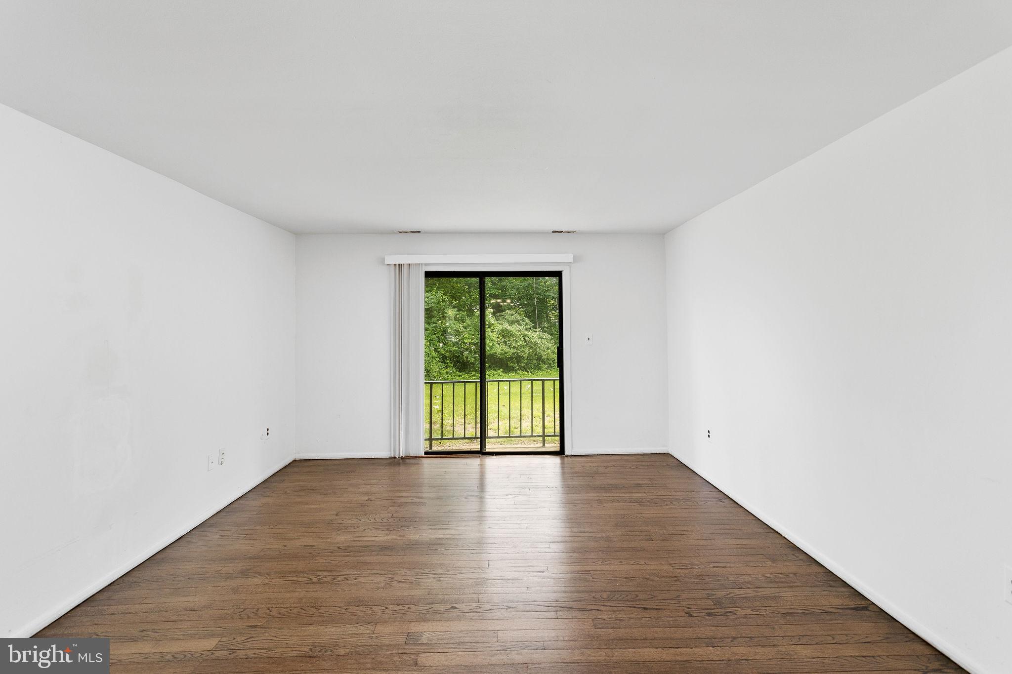 615 Silver Court Hamilton, NJ 08690 - Photo 7 of 22 a view of an empty room with wooden floor and a window