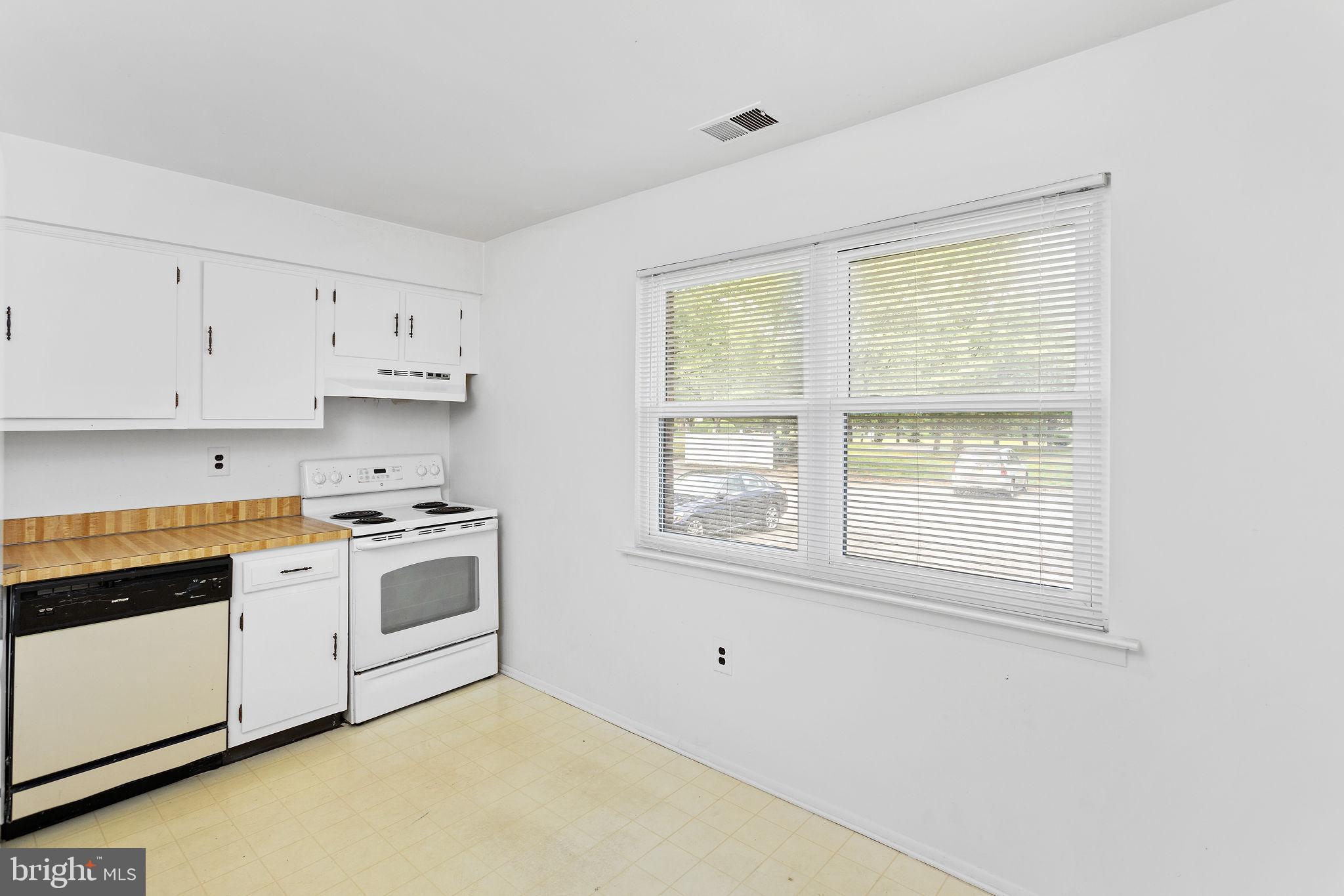 615 Silver Court Hamilton, NJ 08690 - Photo 10 of 22 a kitchen with granite countertop white cabinets and white appliances