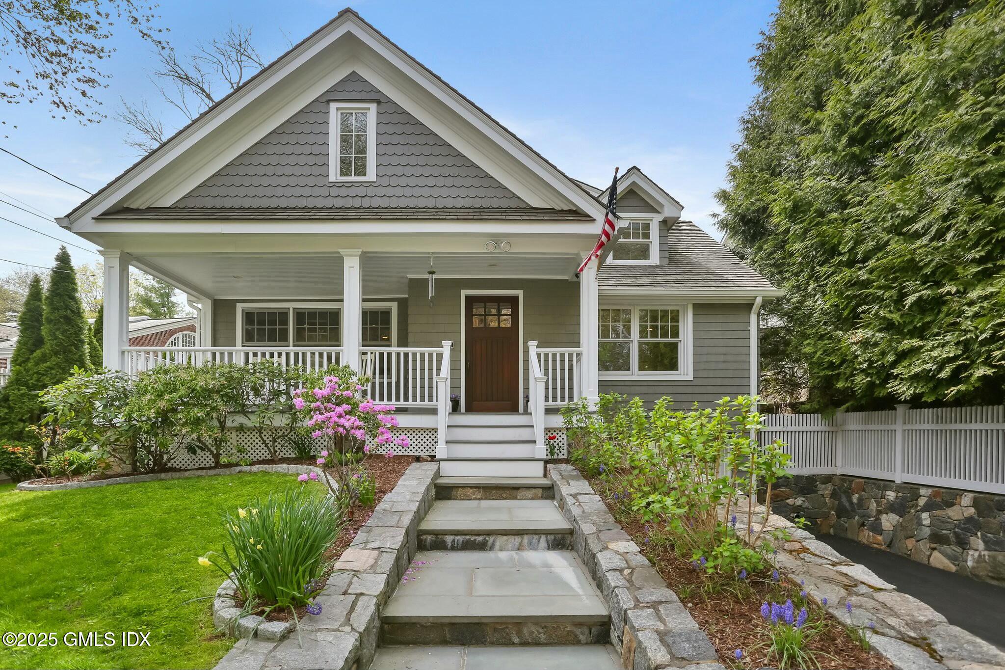 a front view of a house with a garden