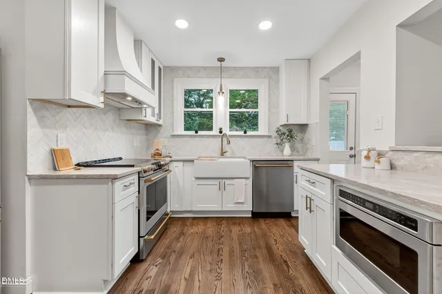 a kitchen with a sink stove and cabinets