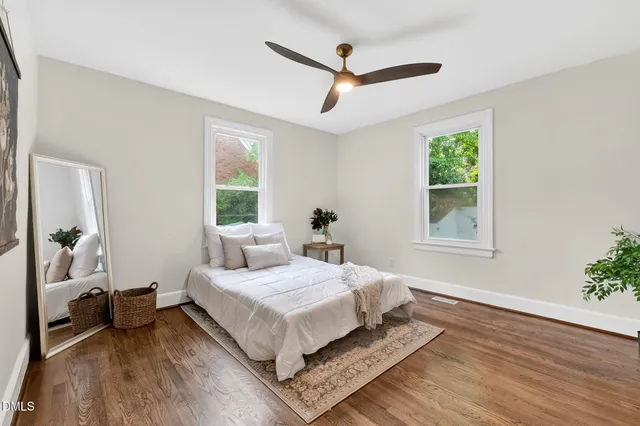 a bedroom with a bed couch and a window