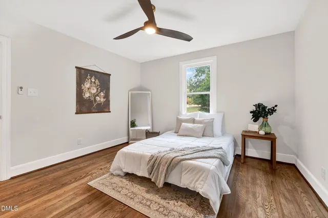 a bedroom with a bed and a potted plant