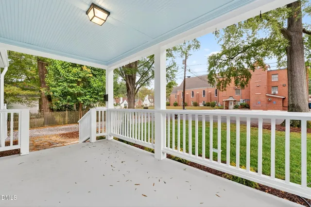 a view of a porch with a floor to ceiling window and wooden fence