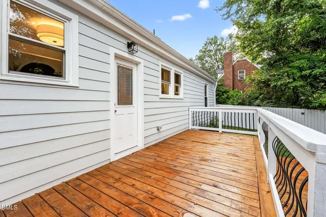 a view of balcony with a wooden floor and fence