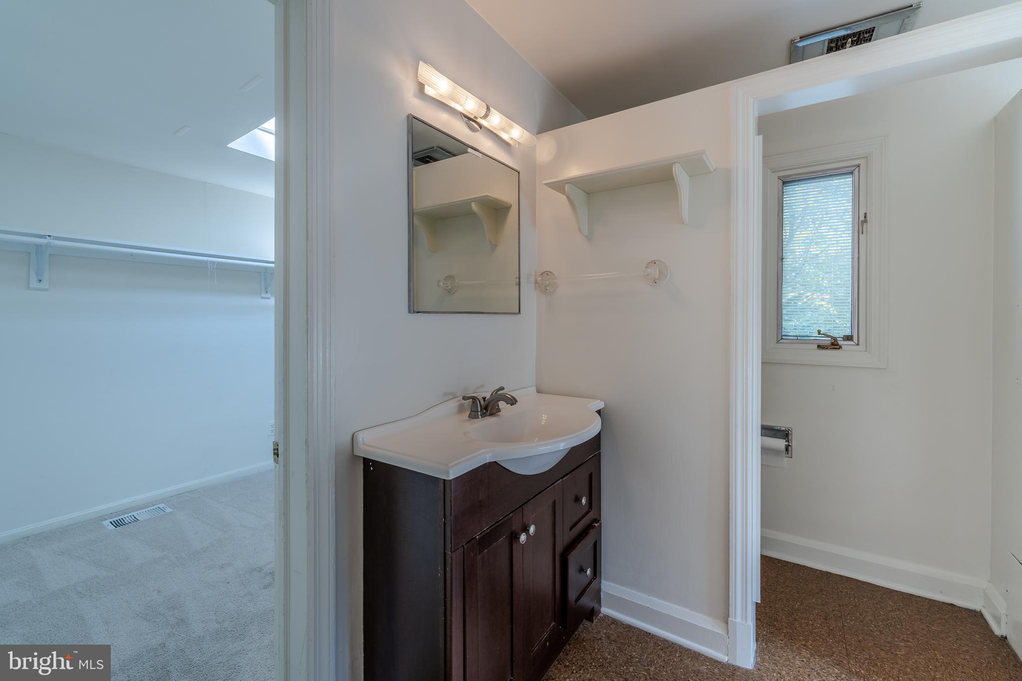 1012 Poplar Hill Road Baltimore, MD 21210 - Photo 16 of 42 a bathroom with a sink mirror and vanity