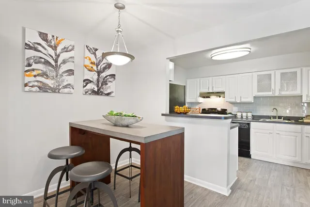a kitchen with a table and chairs in it
