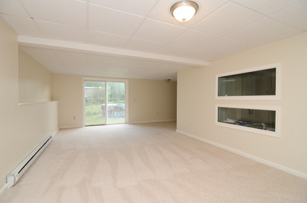 161 Hardwick Road Barre, MA 01005 - Photo 16 of 21 en empty room with windows and fireplace