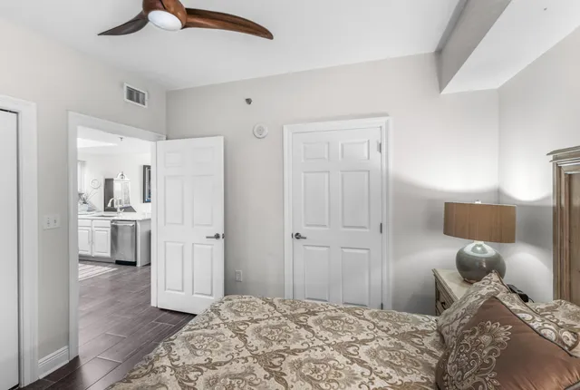 a bedroom with a bed and a view of kitchen