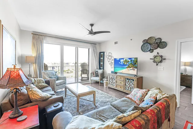 a living room with furniture and a floor to ceiling window