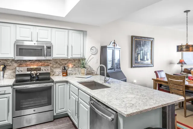 a kitchen with a stove sink and microwave