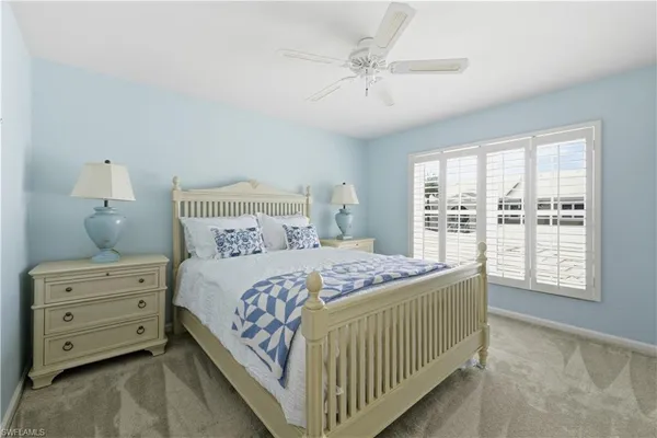 a bedroom with a bed a window and closet