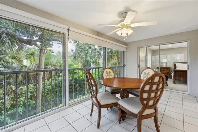 a dining room with furniture a chandelier and wooden floor