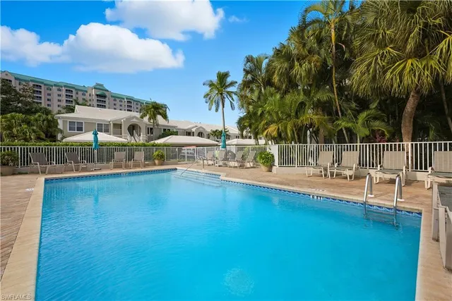 a view of swimming pool with outdoor seating and plants